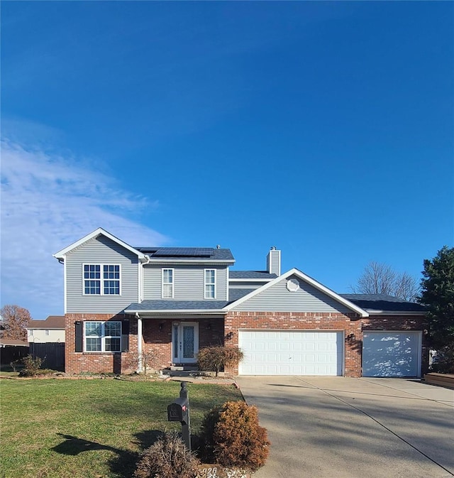 view of property featuring a garage, a front yard, and solar panels