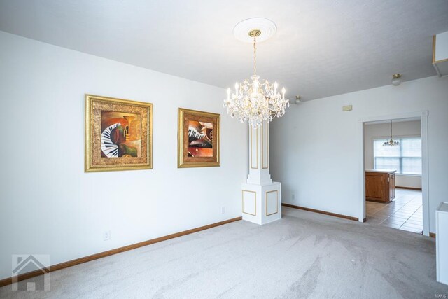 unfurnished room with light colored carpet and a chandelier