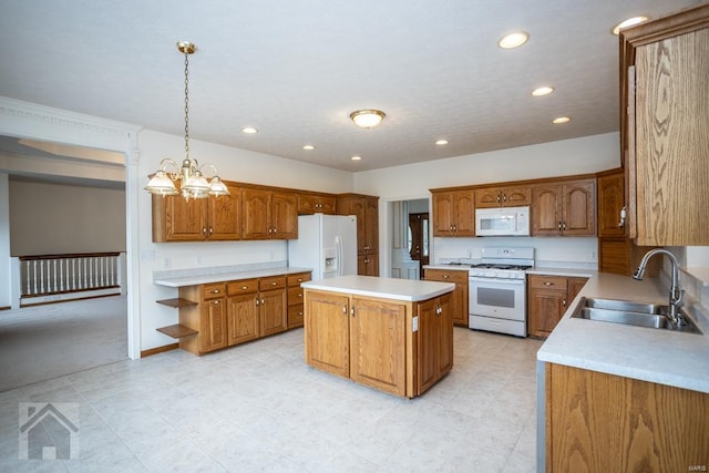 kitchen with a center island, decorative light fixtures, white appliances, a notable chandelier, and sink