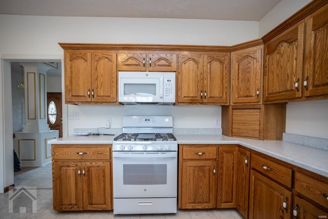 kitchen featuring white appliances and light tile patterned floors