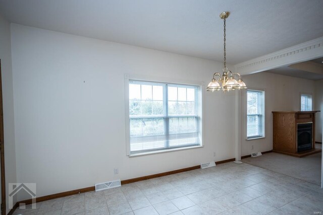 interior space featuring light tile patterned floors and a chandelier