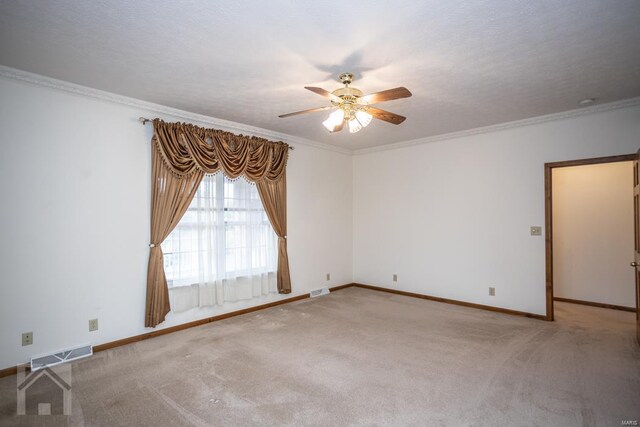 carpeted empty room with crown molding, a textured ceiling, and ceiling fan