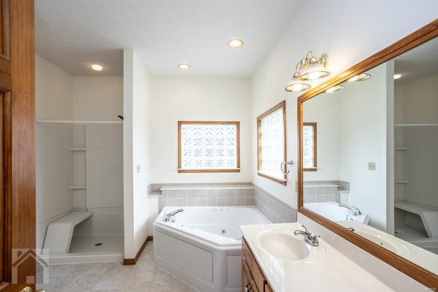 bathroom featuring vanity, independent shower and bath, and tile patterned floors