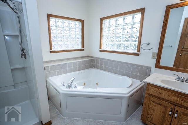 bathroom featuring tile patterned floors, independent shower and bath, and vanity