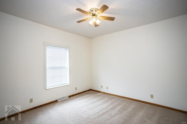 unfurnished room featuring light colored carpet and ceiling fan