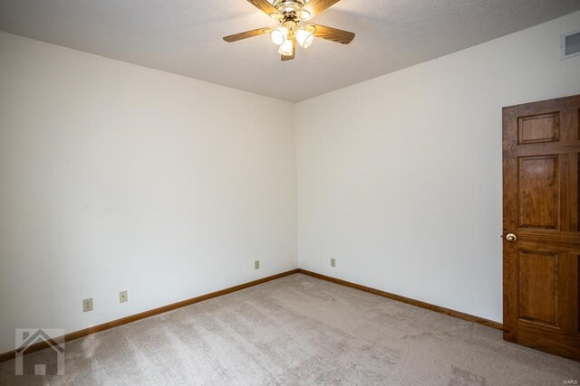 carpeted empty room with a textured ceiling and ceiling fan