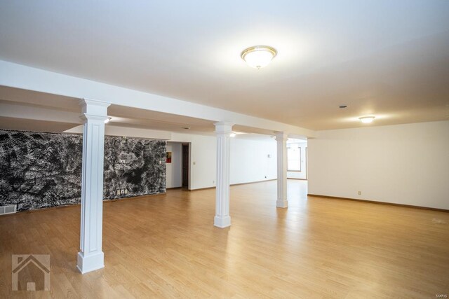 basement with light hardwood / wood-style floors