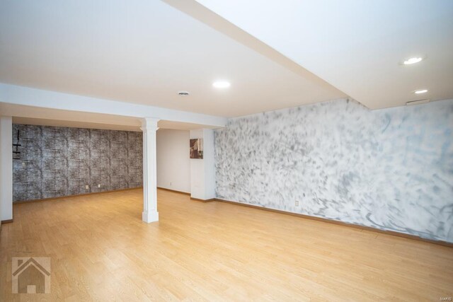 basement with light hardwood / wood-style flooring