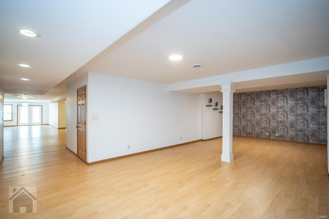 basement with light hardwood / wood-style flooring