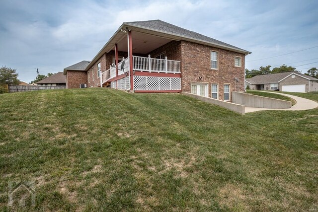 back of house with a yard and a garage