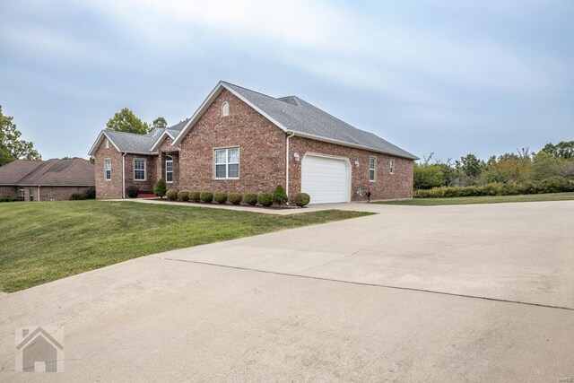 view of front of house featuring a garage and a front lawn