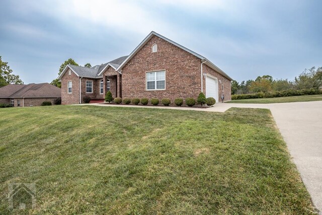 view of front of house with a front yard and a garage