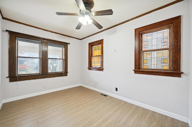 empty room featuring ceiling fan, crown molding, and light hardwood / wood-style floors