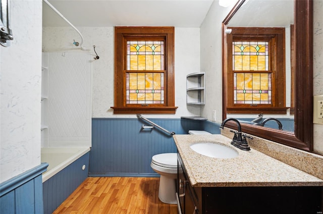 full bathroom featuring vanity, toilet, wood-type flooring, and tub / shower combination