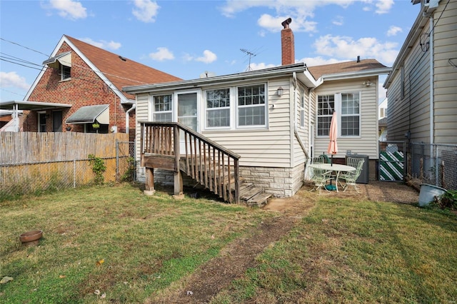 rear view of property with a lawn