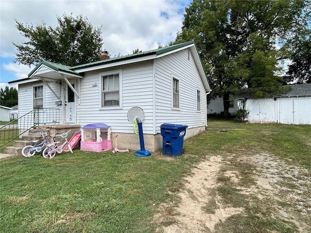 back of house with a yard