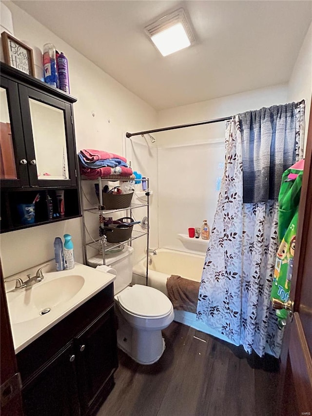 full bathroom with vanity, toilet, wood-type flooring, and shower / bath combination with curtain