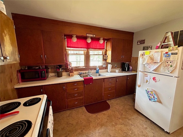 kitchen featuring white appliances and sink