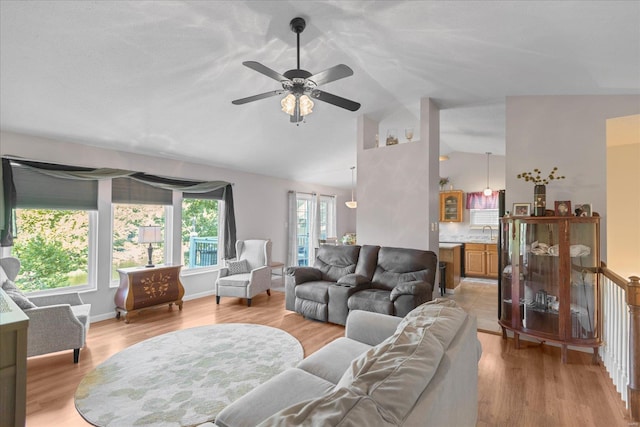 living room featuring light hardwood / wood-style floors and vaulted ceiling