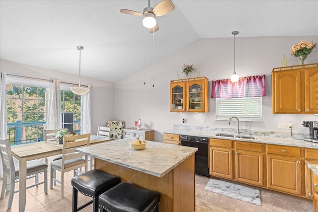 kitchen featuring a center island, ceiling fan, sink, black dishwasher, and lofted ceiling