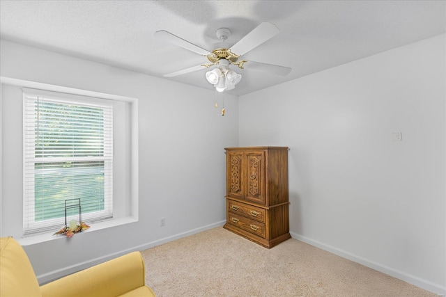 sitting room with light carpet and ceiling fan