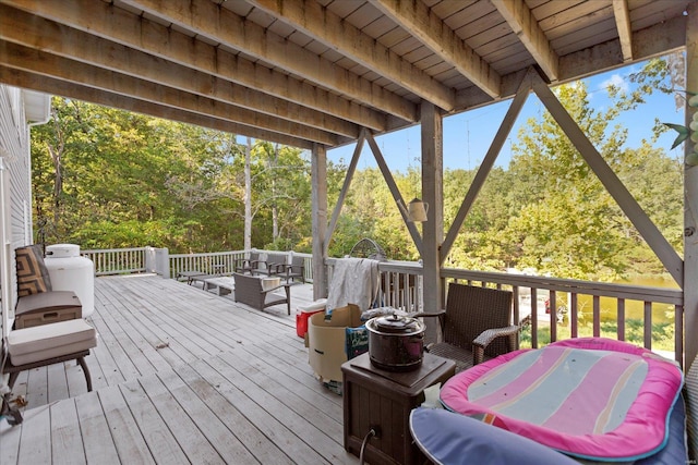 deck with an outdoor living space and a grill