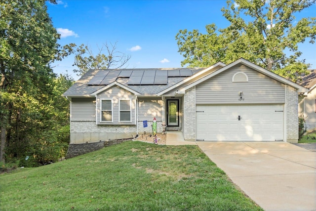 single story home with solar panels, a garage, and a front yard