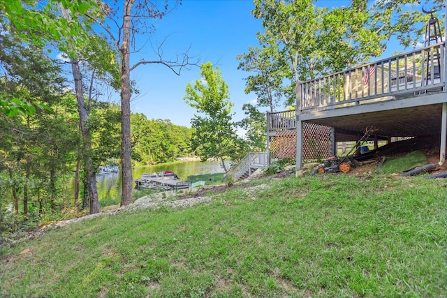 view of yard with a deck with water view