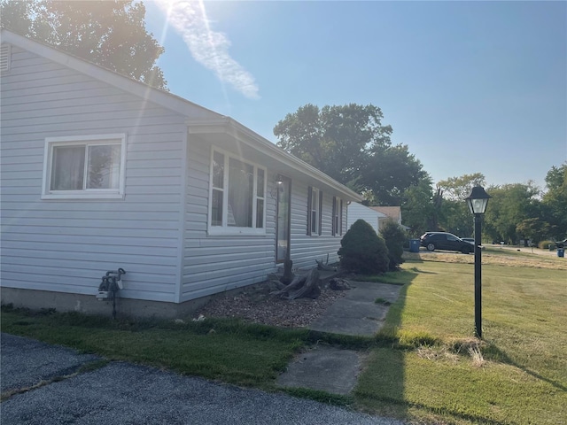 view of side of property with a lawn