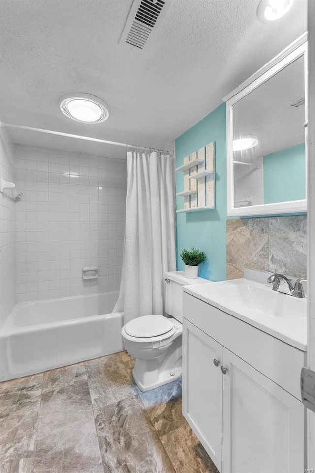 full bathroom with vanity, toilet, a textured ceiling, and shower / tub combo with curtain