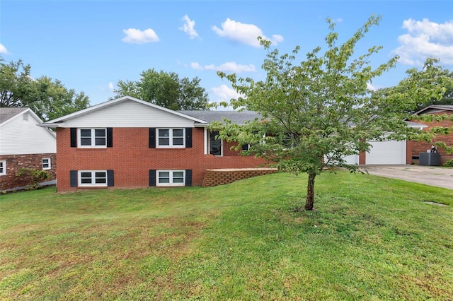 view of front of home with an attached garage, brick siding, driveway, and a front lawn