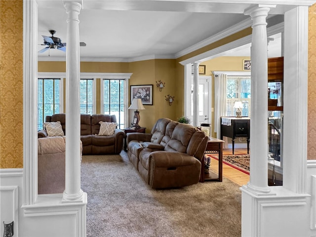 living room with crown molding, ceiling fan, carpet, and decorative columns