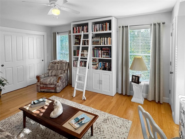 living area featuring ceiling fan and light wood-type flooring