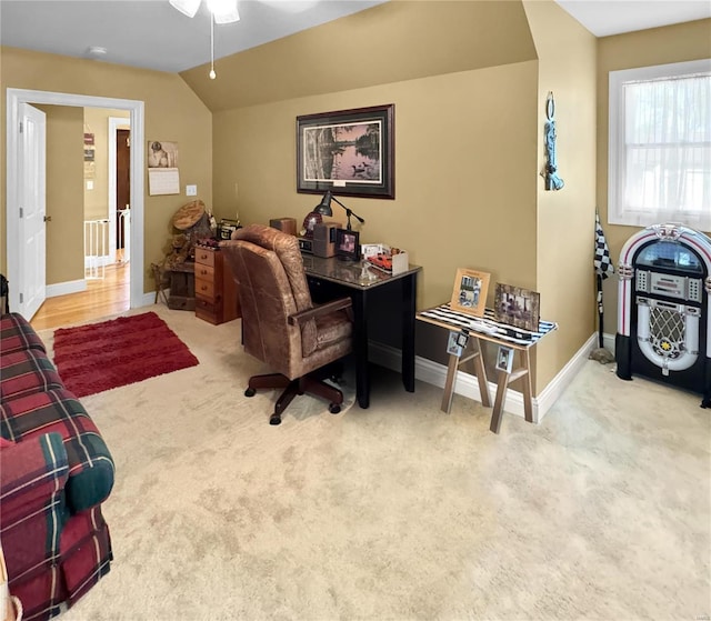 office with lofted ceiling, ceiling fan, and light carpet