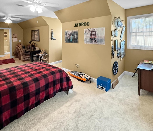 carpeted bedroom with ceiling fan and vaulted ceiling