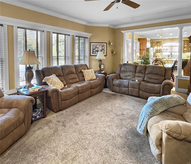 living room featuring carpet flooring, ceiling fan, ornamental molding, and ornate columns