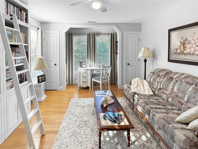 living room featuring ceiling fan and light hardwood / wood-style floors