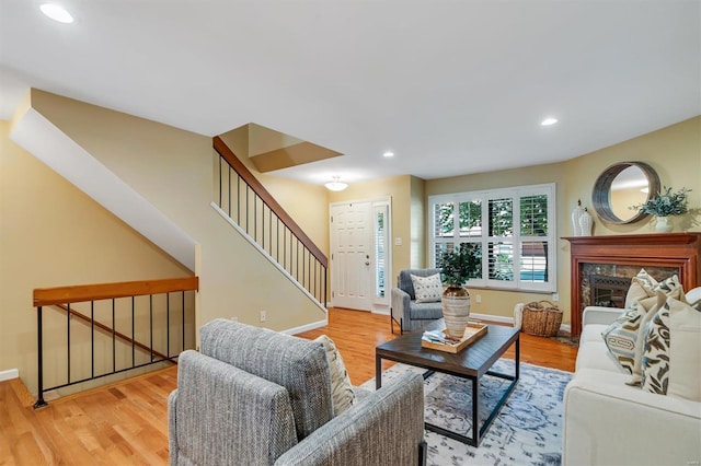 living room featuring light hardwood / wood-style flooring and a premium fireplace