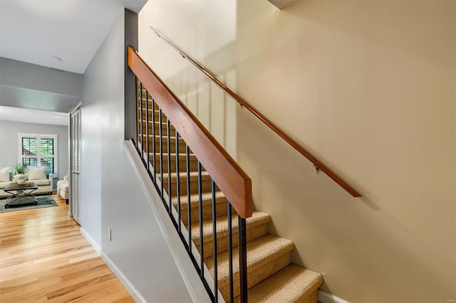 stairway with hardwood / wood-style flooring