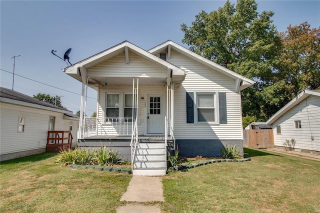 bungalow-style home featuring a front lawn and covered porch