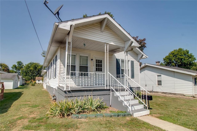 bungalow featuring a porch and a front lawn