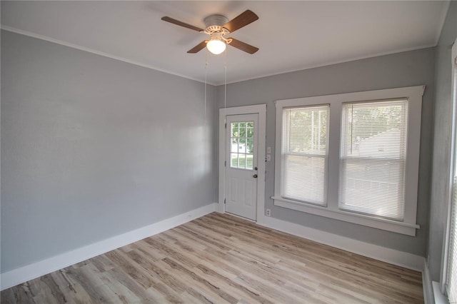 doorway to outside with light wood-type flooring, ceiling fan, and ornamental molding