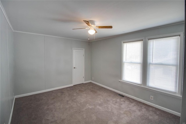 spare room featuring carpet flooring, ceiling fan, and ornamental molding