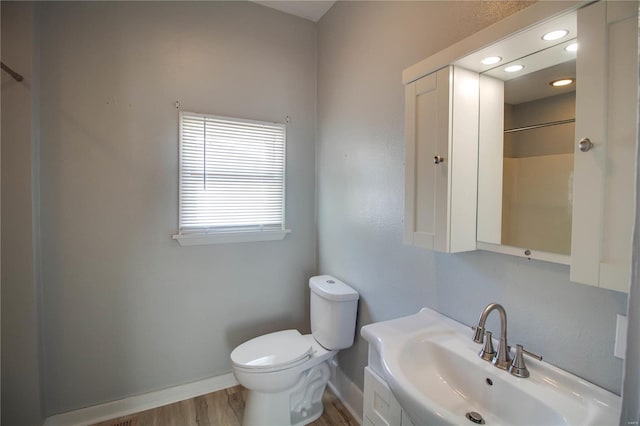 bathroom with walk in shower, toilet, hardwood / wood-style flooring, and vanity