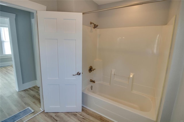 bathroom with hardwood / wood-style floors and shower / bath combination