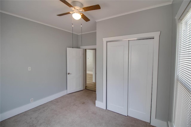 unfurnished bedroom featuring a closet, ceiling fan, ornamental molding, and light carpet