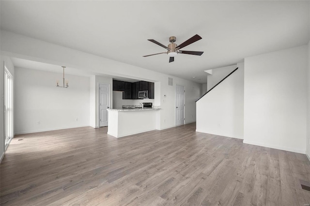 unfurnished living room with hardwood / wood-style floors and ceiling fan