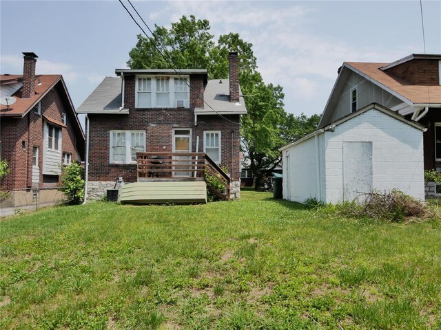 rear view of property with a lawn