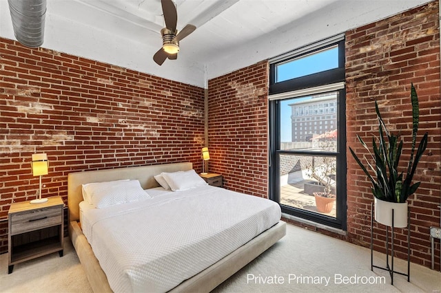 carpeted bedroom featuring brick wall and ceiling fan