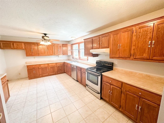 kitchen featuring appliances with stainless steel finishes, sink, a textured ceiling, and ceiling fan